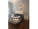 Bright bedroom featuring wood floors, two nightstands, and a large window at 5125 Palm Springs Blvd # 13107, Tampa, FL 33647