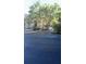 Apartment building surrounded by mature trees with parking at 5125 Palm Springs Blvd # 13107, Tampa, FL 33647
