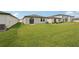 This backyard offers lush green grass, a home with a sliding glass door, and privacy at 14106 Crutchfield Ct, Parrish, FL 34219