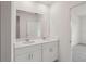 Bathroom featuring double vanity with white countertops and undermount sinks at 14106 Crutchfield Ct, Parrish, FL 34219
