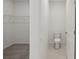Walk in closet and toilet room featuring light neutral paint and flooring at 14106 Crutchfield Ct, Parrish, FL 34219
