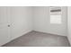 This bedroom features neutral carpet and a window that lets in natural light at 14106 Crutchfield Ct, Parrish, FL 34219