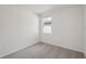 This bedroom features neutral carpet and a window that lets in natural light at 14106 Crutchfield Ct, Parrish, FL 34219