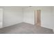 Clean bedroom with neutral carpet and an open doorway to another room at 14106 Crutchfield Ct, Parrish, FL 34219