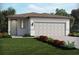 Charming single-story home featuring an attached two-car garage and well-maintained landscaping at 14106 Crutchfield Ct, Parrish, FL 34219