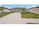 Charming exterior view of a one story home with a wide driveway at 14106 Crutchfield Ct, Parrish, FL 34219