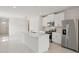 Bright kitchen with white cabinets, stainless steel appliances, and a quartz island at 14106 Crutchfield Ct, Parrish, FL 34219