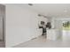 Open living room with light tile flooring and an open-concept kitchen at 14106 Crutchfield Ct, Parrish, FL 34219