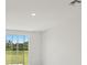 Bright living room with sliding glass doors providing a view of the lush backyard at 14106 Crutchfield Ct, Parrish, FL 34219