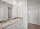 Bathroom featuring a double-sink vanity with a stone countertop and a glass-enclosed shower at 149 Whiteland Bnd, Nokomis, FL 34275