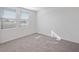 Bright bedroom with two windows, carpet flooring, and neutral color scheme at 149 Whiteland Bnd, Nokomis, FL 34275