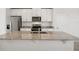 Close-up of eat-in kitchen island featuring a stainless steel sink and granite countertop at 149 Whiteland Bnd, Nokomis, FL 34275