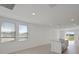 Bright living room with two windows, recessed lighting, and luxury vinyl plank flooring at 149 Whiteland Bnd, Nokomis, FL 34275