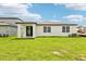 Large backyard featuring a covered patio area perfect for outdoor relaxation and entertaining at 1752 Brekey Way, Zephyrhills, FL 33541