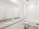 Elegant bathroom featuring a double vanity with granite countertop and modern fixtures at 1752 Brekey Way, Zephyrhills, FL 33541