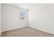 Bright, carpeted bedroom with a window providing natural light and a serene view at 1752 Brekey Way, Zephyrhills, FL 33541