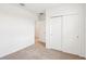 Cozy bedroom featuring a closet with sliding doors and neutral carpeting throughout at 1752 Brekey Way, Zephyrhills, FL 33541