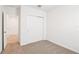 Comfortable bedroom with closet, neutral carpeting, and convenient access to other rooms at 1752 Brekey Way, Zephyrhills, FL 33541