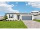 Charming single-story home with a well-manicured lawn, brick driveway and an attached two-car garage at 1752 Brekey Way, Zephyrhills, FL 33541