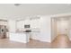 Bright, open kitchen featuring stainless steel appliances, granite counters, a kitchen island, and tile flooring at 1752 Brekey Way, Zephyrhills, FL 33541