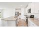 Open-concept kitchen boasting stainless steel appliances, granite countertops, white cabinets, and tile floors at 1752 Brekey Way, Zephyrhills, FL 33541