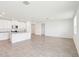Open-concept floor plan with kitchen that features stainless steel appliances, granite counters, white cabinets, and tile floors at 1752 Brekey Way, Zephyrhills, FL 33541