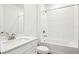 Bright bathroom featuring a shower over tub with white tiles and a modern vanity with a white countertop at 1787 Draughton Dr, Zephyrhills, FL 33541