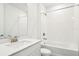 Clean bathroom with modern vanity, tub, and tiled shower with bright lighting at 1787 Draughton Dr, Zephyrhills, FL 33541
