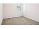 A bedroom offers carpet, white walls, baseboard trim and a window with blinds at 1787 Draughton Dr, Zephyrhills, FL 33541