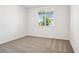 Inviting bedroom with plush carpet and a window overlooking a serene view at 1787 Draughton Dr, Zephyrhills, FL 33541