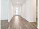 Bright foyer featuring beautiful wood-look tile flooring and a modern front door at 1787 Draughton Dr, Zephyrhills, FL 33541