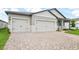A charming home with a spacious three car garage and a beautiful paved driveway at 1787 Draughton Dr, Zephyrhills, FL 33541