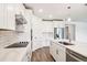 Modern kitchen with stainless steel appliances, white cabinetry, and quartz countertops at 1787 Draughton Dr, Zephyrhills, FL 33541