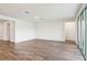 Spacious living room with wood-look tile flooring, recessed lighting, and large sliding glass doors at 1787 Draughton Dr, Zephyrhills, FL 33541