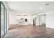 Spacious living room with tiled floors and sliding glass doors leading to the outdoor patio and a kitchen area at 1787 Draughton Dr, Zephyrhills, FL 33541