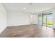 Bright living room with tiled floors and sliding glass doors leading to the outdoor patio at 1787 Draughton Dr, Zephyrhills, FL 33541