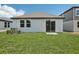 Backyard featuring a lush green lawn and a sliding glass door leading indoors at 1839 Brekey Way, Zephyrhills, FL 33541