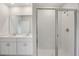 Modern bathroom with double sinks, quartz countertops and a glass-enclosed shower at 1839 Brekey Way, Zephyrhills, FL 33541