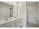 Modern bathroom with double sinks, quartz countertops and a glass-enclosed shower at 1839 Brekey Way, Zephyrhills, FL 33541
