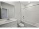 Bathroom with a bathtub, shower, a white vanity, and a white tile backsplash at 1839 Brekey Way, Zephyrhills, FL 33541