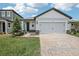 Charming single-Gathering home with a two-car garage and a beautifully landscaped front yard at 1839 Brekey Way, Zephyrhills, FL 33541