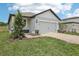 Charming single-Gathering home with a two-car garage and a beautifully landscaped front yard at 1839 Brekey Way, Zephyrhills, FL 33541