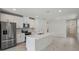 Modern kitchen with stainless steel appliances, quartz countertops and an island with a sink at 1839 Brekey Way, Zephyrhills, FL 33541
