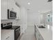 Modern kitchen with stainless steel appliances, white cabinets, and hard surface countertops at 1839 Brekey Way, Zephyrhills, FL 33541