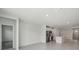 Open-concept living room area with view into the kitchen, featuring hard surface floors and natural light at 1839 Brekey Way, Zephyrhills, FL 33541