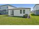 Well-maintained backyard featuring lush green grass, a sliding glass door, and a side yard at 1861 Brekey Way, Zephyrhills, FL 33541