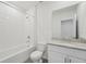 Bathroom features a shower-tub combo, a granite vanity, and modern fixtures at 1861 Brekey Way, Zephyrhills, FL 33541