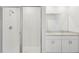 Bathroom highlighting a modern vanity with double sinks, granite countertops, and a walk-in shower with white tiling at 1861 Brekey Way, Zephyrhills, FL 33541