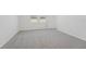 Bedroom with neutral carpeting, bright windows, and white walls at 1861 Brekey Way, Zephyrhills, FL 33541