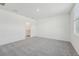 Bedroom with neutral carpeting, bright window, and ensuite bathroom at 1861 Brekey Way, Zephyrhills, FL 33541